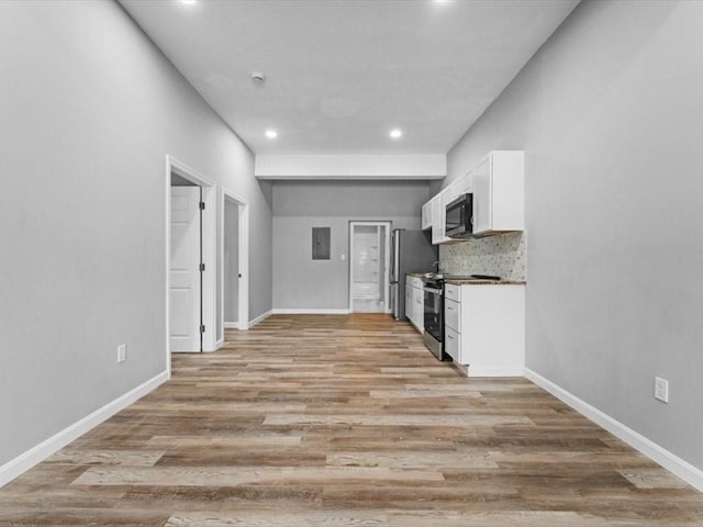 273 Elm St, Southbridge, MA 01550 - kitchen featuring stainless steel appliances, white cabinetry, recessed lighting, electric panel, and light wood-style flooring