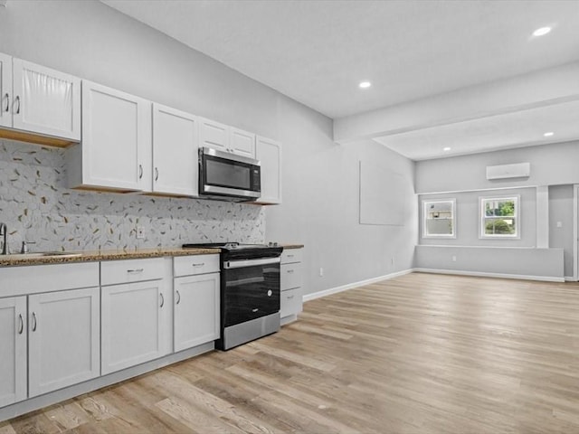 273 Elm St, Southbridge, MA 01550 - kitchen with appliances with stainless steel finishes, light wood-style flooring, white cabinetry, decorative backsplash, and recessed lighting