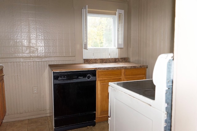 kitchen featuring black dishwasher and light tile patterned floors