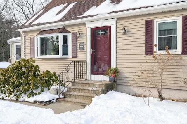 view of snow covered property entrance