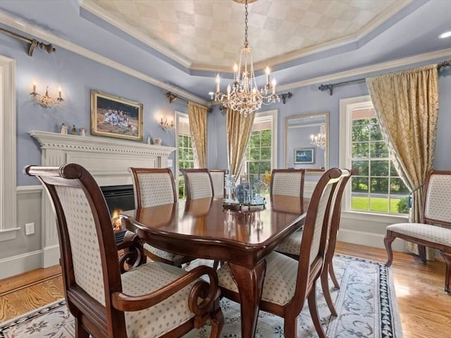 35 Oxbow Dr, Wrentham, MA 02093 - dining area featuring crown molding, a chandelier, a tray ceiling, plenty of natural light, and wood finished floors