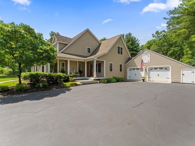 35 Oxbow Dr, Wrentham, MA 02093 - view of front facade with a porch, asphalt driveway, and a garage