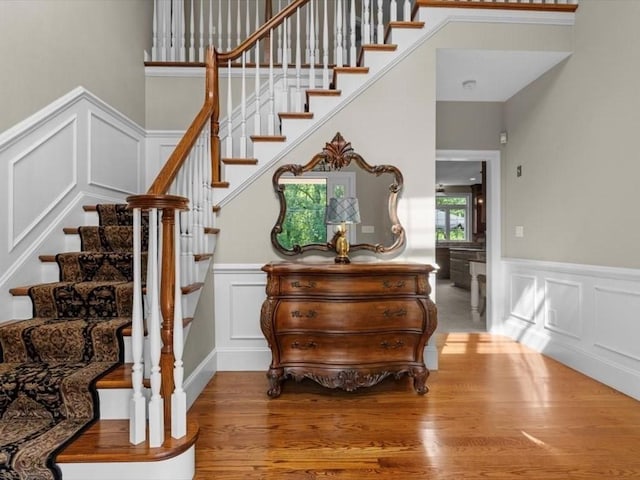 35 Oxbow Dr, Wrentham, MA 02093 - staircase with a decorative wall, wainscoting, and wood finished floors