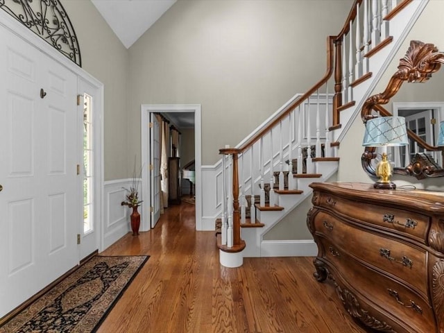 35 Oxbow Dr, Wrentham, MA 02093 - foyer entrance with wood finished floors, stairs, a wainscoted wall, and high vaulted ceiling