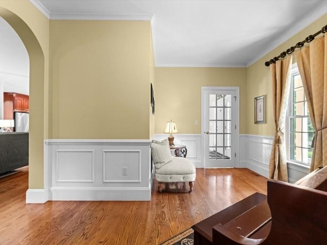 35 Oxbow Dr, Wrentham, MA 02093 - living area featuring wood finished floors, arched walkways, ornamental molding, and wainscoting