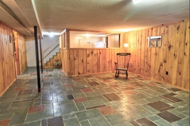 31 Lee Ave, Fitchburg, MA 01420 - finished basement featuring wood walls, a textured ceiling, stairway, and baseboards