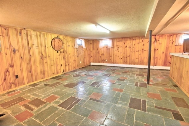 31 Lee Ave, Fitchburg, MA 01420 - basement featuring wooden walls and a textured ceiling