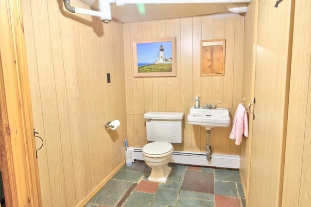 31 Lee Ave, Fitchburg, MA 01420 - half bath featuring a baseboard heating unit, toilet, stone finish flooring, and wooden walls