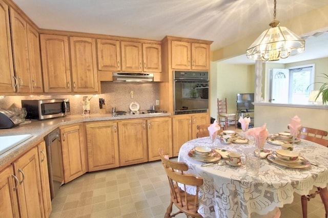 31 Lee Ave, Fitchburg, MA 01420 - kitchen with appliances with stainless steel finishes, exhaust hood, a chandelier, light countertops, and tasteful backsplash