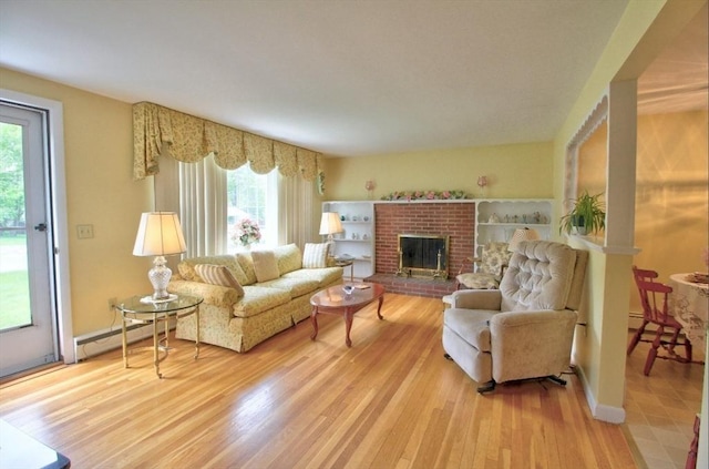 31 Lee Ave, Fitchburg, MA 01420 - living room featuring a baseboard heating unit, wood finished floors, and a fireplace
