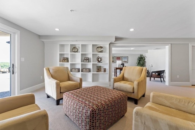 living area featuring light carpet