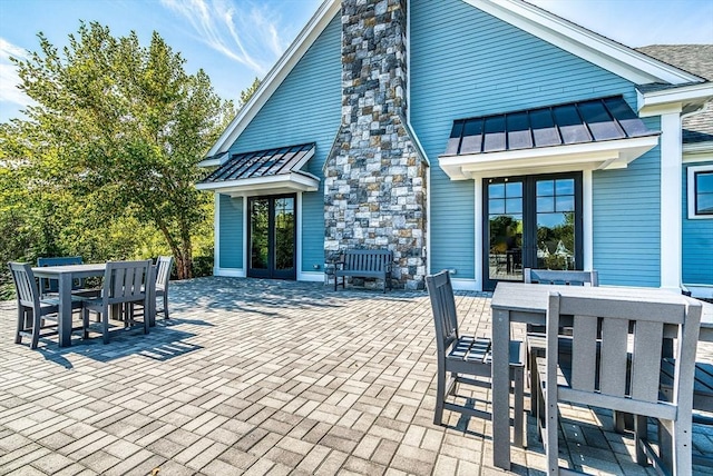 rear view of property with a patio area and french doors