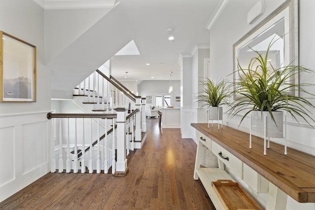 corridor with dark hardwood / wood-style floors and crown molding