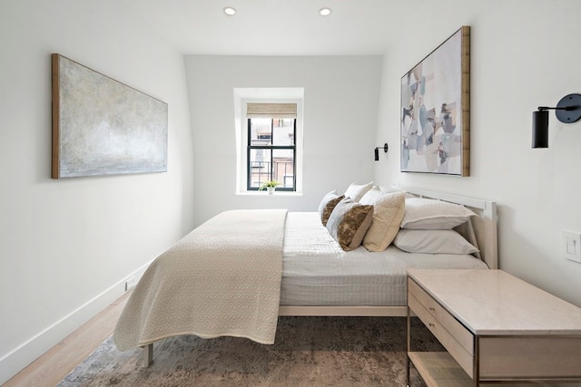 bedroom with dark hardwood / wood-style floors