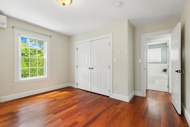 17 Perry St, Somerville, MA 02143 - unfurnished bedroom with dark wood-type flooring, a closet, and an AC wall unit