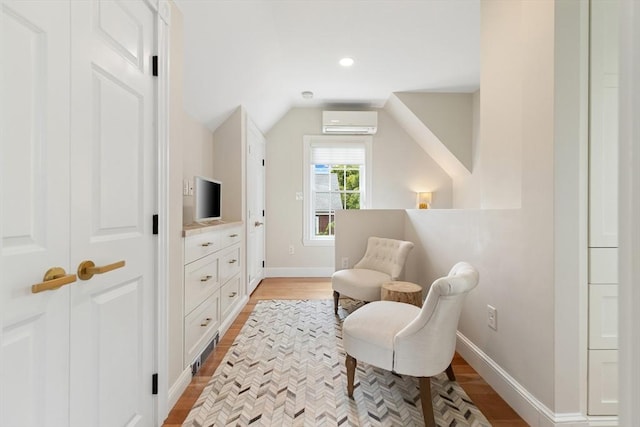 17 Perry St, Somerville, MA 02143 - living area with an AC wall unit, light wood-style flooring, lofted ceiling, and recessed lighting