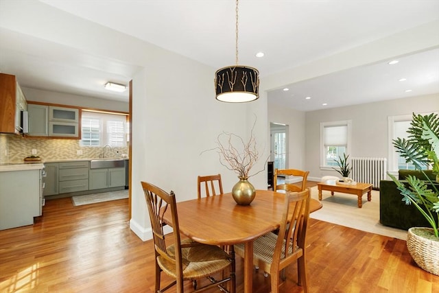 17 Perry St, Somerville, MA 02143 - dining area with light wood finished floors, plenty of natural light, recessed lighting, and radiator heating unit