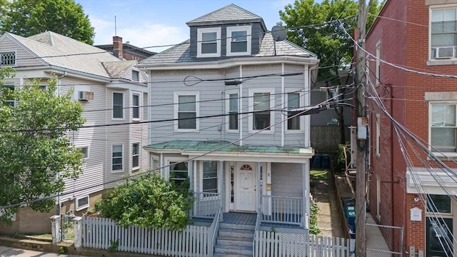 8 Ward St, Salem, MA 01970 - view of front facade with covered porch, a fenced front yard, cooling unit, and a gate