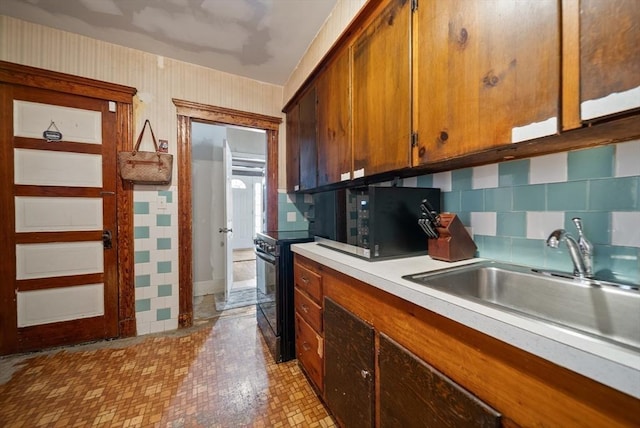 8 Ward St, Salem, MA 01970 - kitchen with black appliances, light countertops, decorative backsplash, brown cabinets, and wallpapered walls