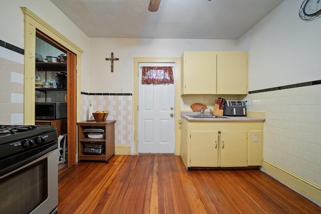 8 Ward St, Salem, MA 01970 - kitchen with stainless steel appliances, tile walls, light countertops, wood finished floors, and ceiling fan