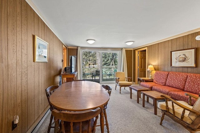 dining space with dark colored carpet and wooden walls