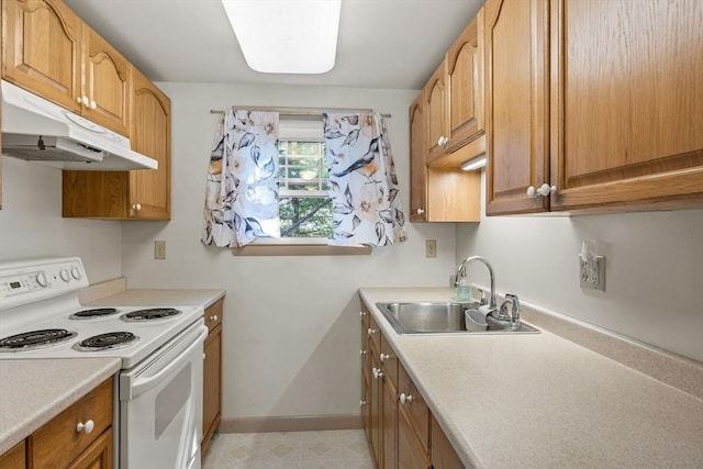 kitchen with white electric range, a sink, under cabinet range hood, and light countertops