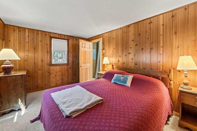 bedroom with wooden walls and carpet flooring
