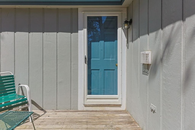 property entrance featuring board and batten siding