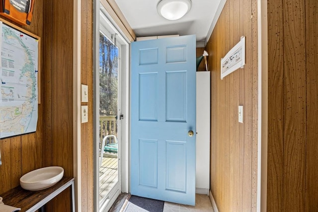 doorway with wood walls