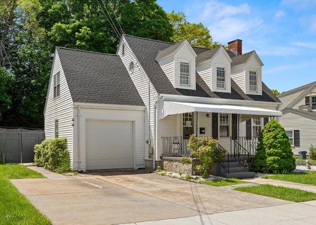 23 Lenox Cir, Lawrence, MA 01843 - new england style home featuring covered porch, concrete driveway, an attached garage, a chimney, and roof with shingles
