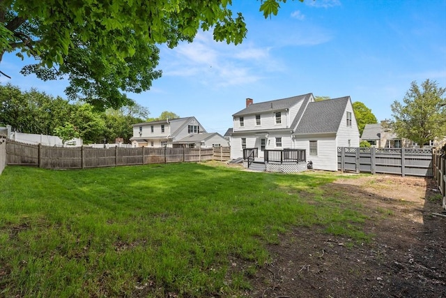 23 Lenox Cir, Lawrence, MA 01843 - back of house with a deck and a chimney