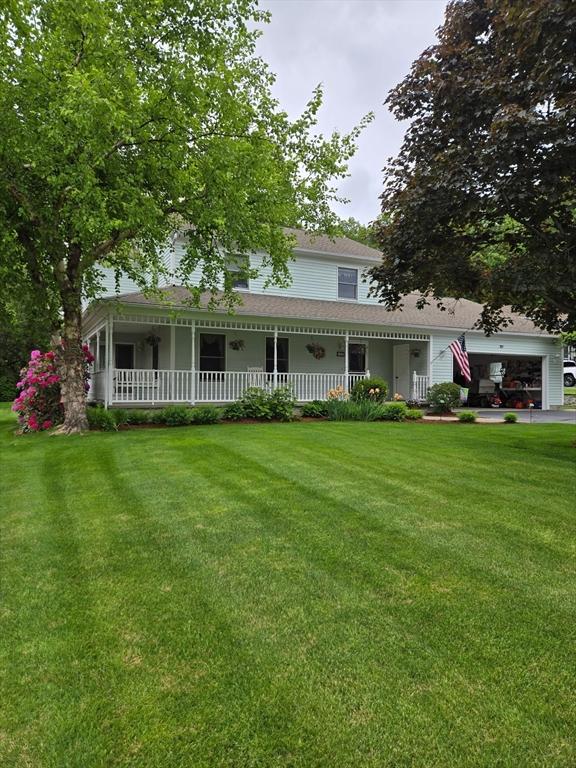 127 Parker Ln, Ludlow, MA 01056 - farmhouse inspired home with covered porch, a front yard, a garage, and roof with shingles