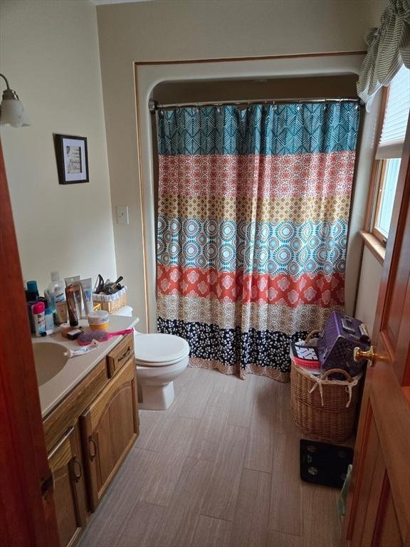 127 Parker Ln, Ludlow, MA 01056 - full bathroom featuring toilet, vanity, and a shower with shower curtain