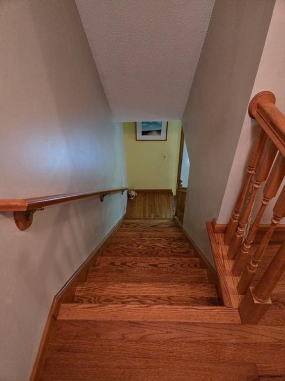 127 Parker Ln, Ludlow, MA 01056 - stairs with wood finished floors, a textured ceiling, and vaulted ceiling