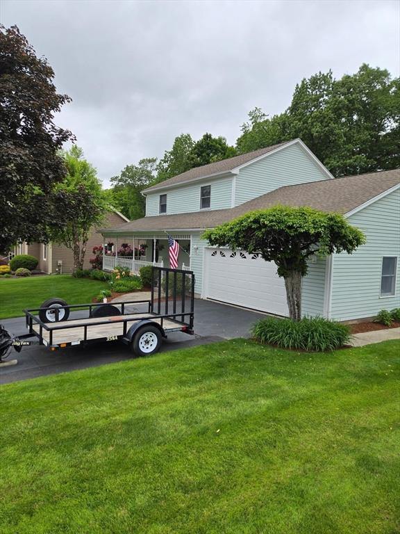 127 Parker Ln, Ludlow, MA 01056 - view of front of property with driveway, a front yard, and a shingled roof