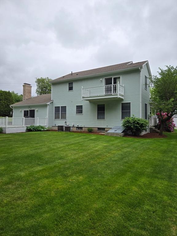 127 Parker Ln, Ludlow, MA 01056 - rear view of property with a balcony, a yard, and a chimney