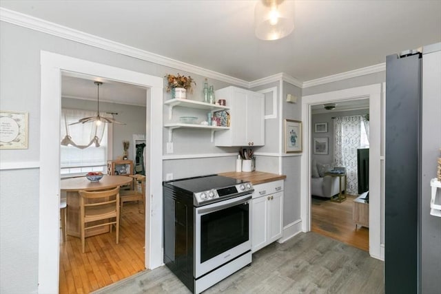 kitchen featuring crown molding, range with electric stovetop, light wood-style floors, white cabinets, and open shelves