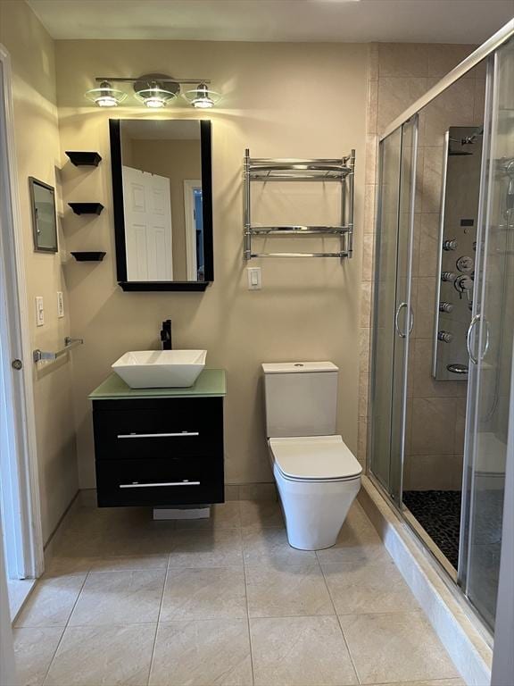 bathroom featuring toilet, a stall shower, tile patterned floors, and vanity