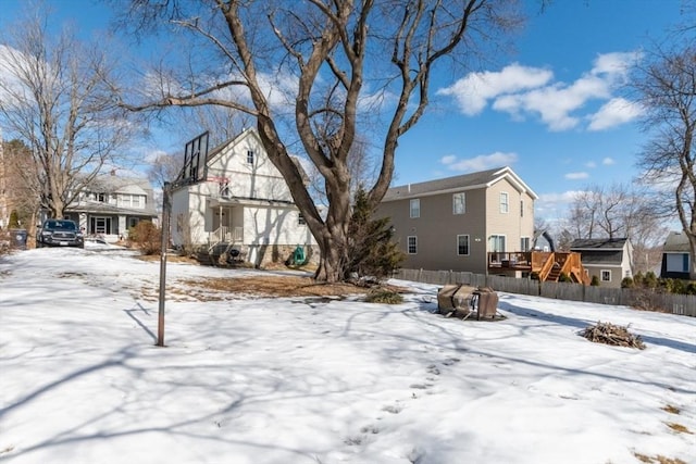 snowy yard with fence and a residential view