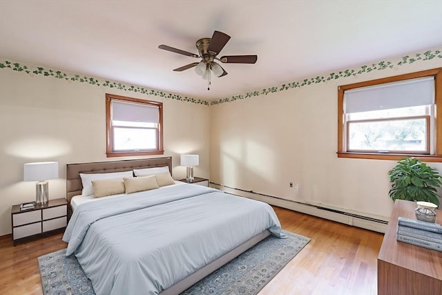 46 Birchland Ave, Springfield, MA 01119 - bedroom featuring multiple windows, a baseboard radiator, and light wood-style floors
