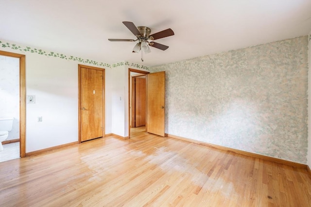 46 Birchland Ave, Springfield, MA 01119 - unfurnished bedroom with light wood-style flooring, wallpapered walls, ensuite bathroom, and ceiling fan
