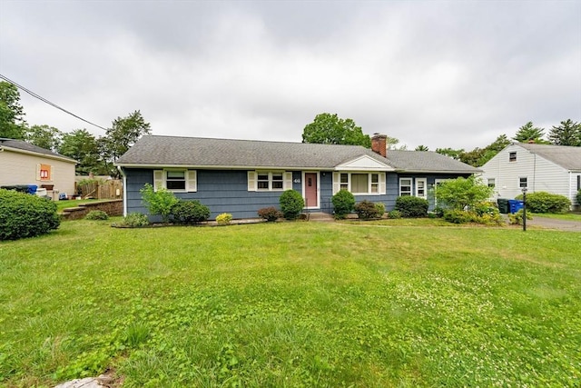 46 Birchland Ave, Springfield, MA 01119 - view of front of house with a chimney, a front lawn, and a shingled roof
