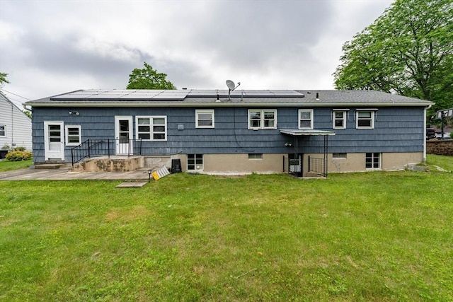 46 Birchland Ave, Springfield, MA 01119 - rear view of house with a yard and roof mounted solar panels