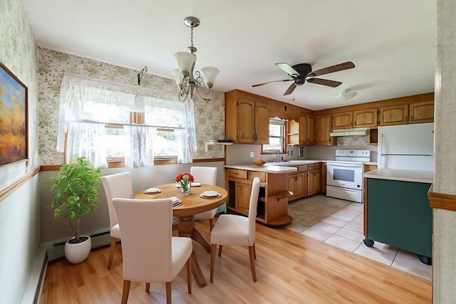 46 Birchland Ave, Springfield, MA 01119 - kitchen with white appliances, brown cabinets, under cabinet range hood, light countertops, and wallpapered walls