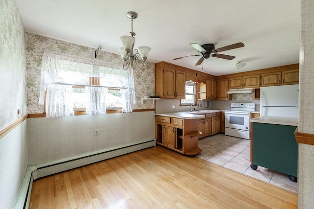 46 Birchland Ave, Springfield, MA 01119 - kitchen with white appliances, brown cabinetry, light countertops, under cabinet range hood, and wallpapered walls