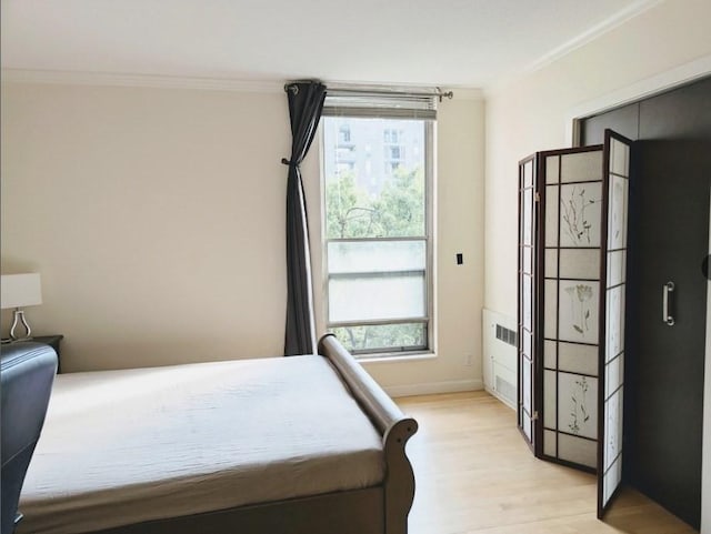 99 Pond Ave Unit 608, Brookline, MA 02445 - bedroom featuring crown molding and light wood finished floors