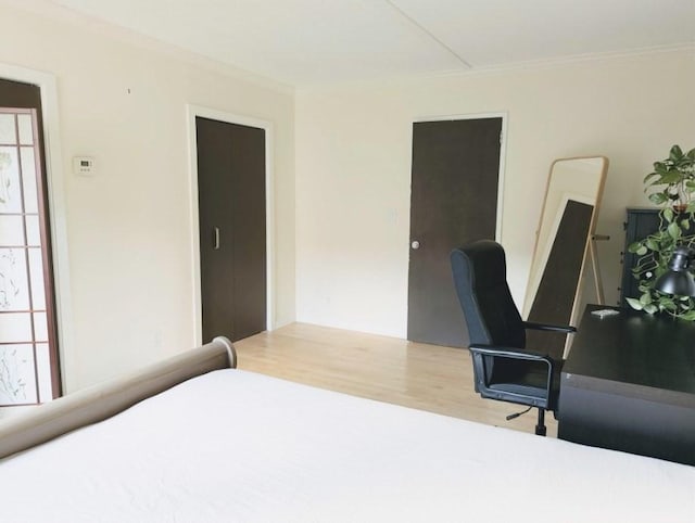 99 Pond Ave Unit 608, Brookline, MA 02445 - bedroom featuring wood finished floors, crown molding, and a desk
