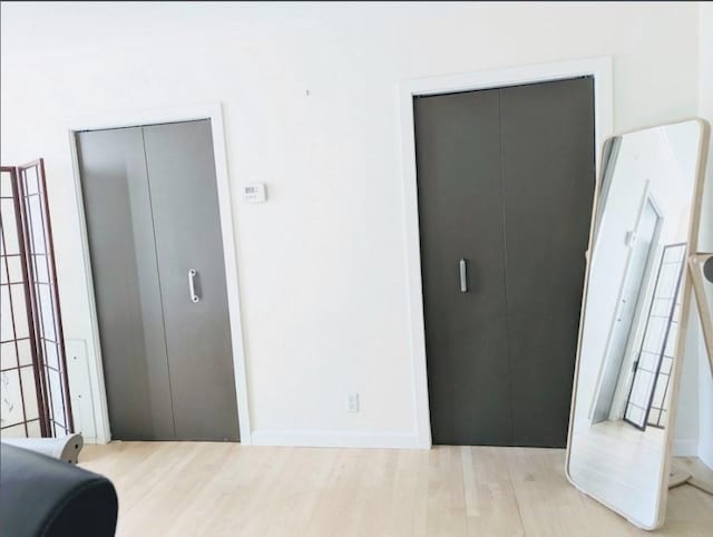 99 Pond Ave Unit 608, Brookline, MA 02445 - bedroom with light wood-type flooring and baseboards
