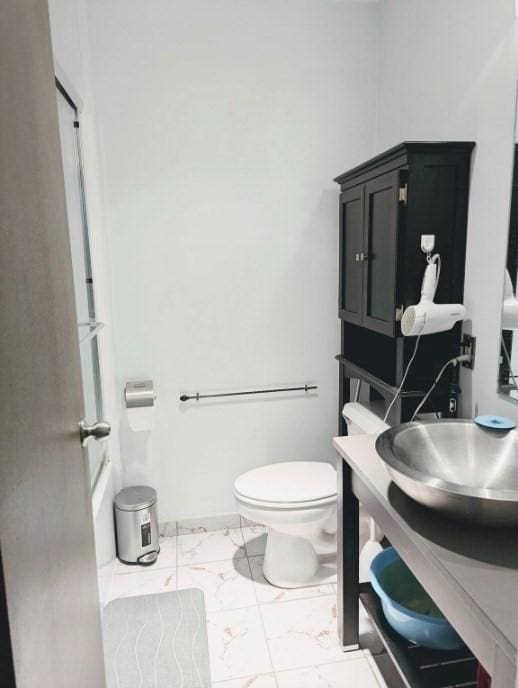 99 Pond Ave Unit 608, Brookline, MA 02445 - full bath with marble look tile flooring, vanity, and bathtub / shower combination
