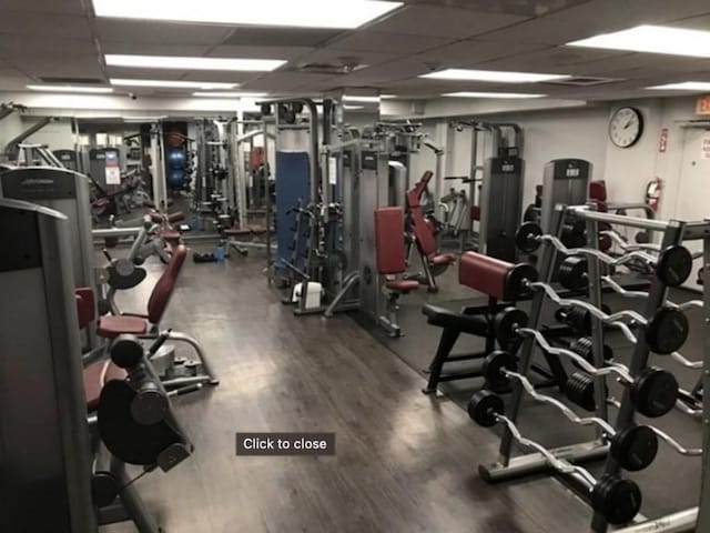 99 Pond Ave Unit 608, Brookline, MA 02445 - gym with a paneled ceiling and wood finished floors